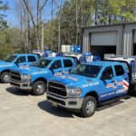 three prop wash trucks in front of warehouse