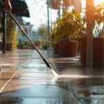 spraying sidewalk outside of business