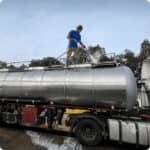 man power washing a fuel tank