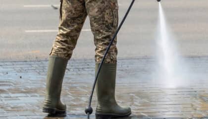 man power washing concrete sidewalk