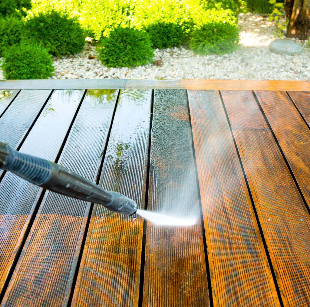 spraying grime off wooden deck