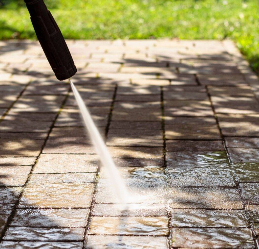 close-up of someone power washing patio