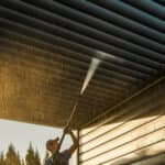 gentleman power washing outdoor patio