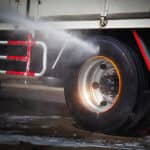 close-up of tire truck getting power washed
